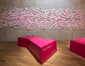 Pink post-its on a wall