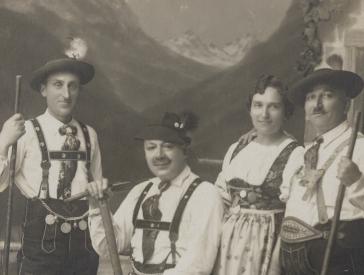 Black and white photo of a group of people in traditional Bavarian costumes.