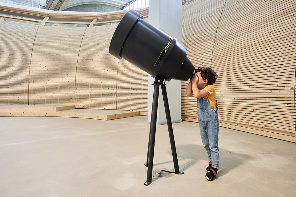 Child at telescope.