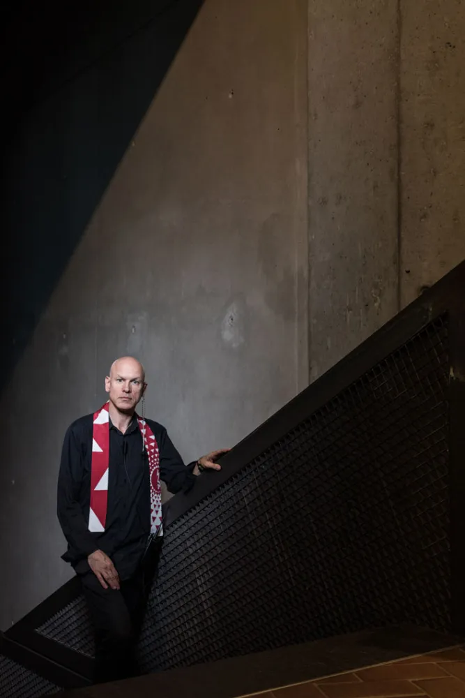 A man is standing on the stairs leading to the axes in the Libeskind Building