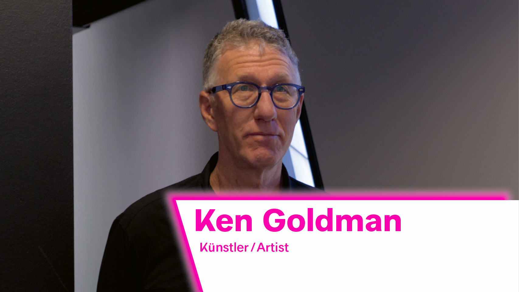 The image shows artist Ken Goldman. He is wearing a black shirt and glasses.