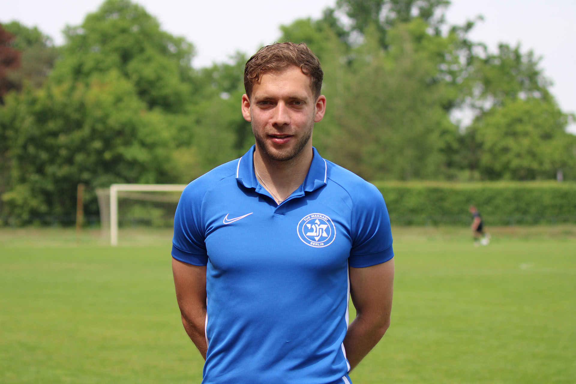 A man in a blue soccer jersey