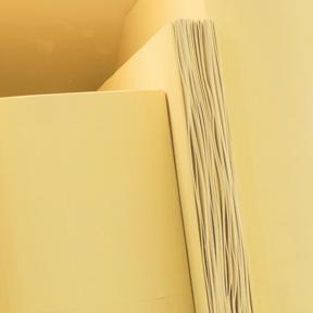 Close-up of the installation with wooden book sculptures in yellow.