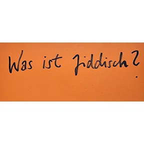 Handschrift Schwarz auf Orange: Was ist Jiddisch?