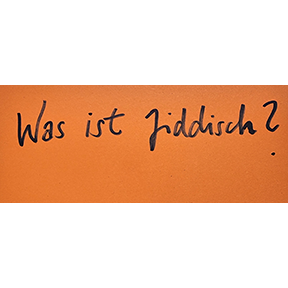 Handschrift Schwarz auf Orange: Was ist Jiddisch? 