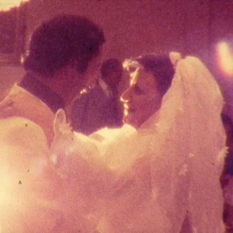 An old photograph: a wedding couple dancing.