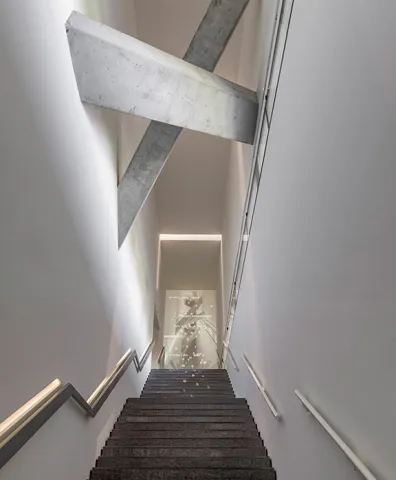 Long staircase with projected Hebrew and Latin letters that form city names