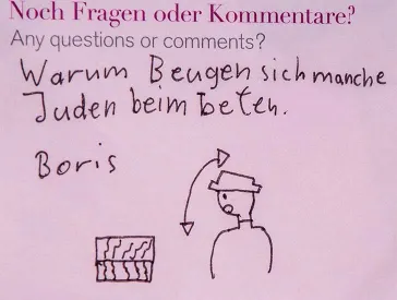 A pink post-it note labeled “Why do some Jews rock back and forth when they pray?”