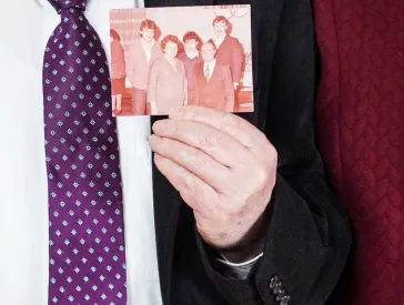 Older couple with a photograph in their hands.