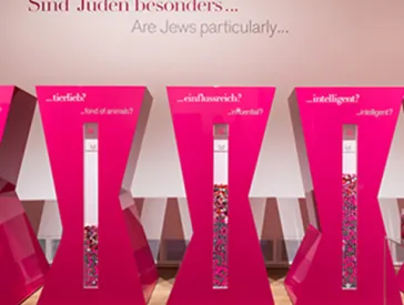 Five pillars with the inscriptions: "business savy?", "fond of animals?", "influential?", "intelligent?", "beautiful?"