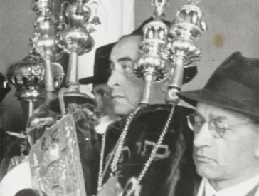 Men hold Torah scrolls in their hands.