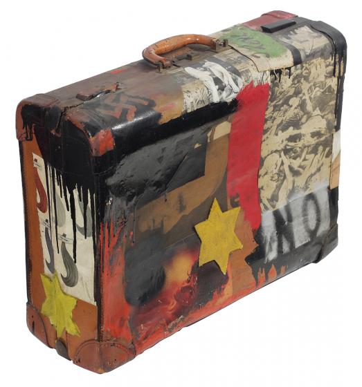 The image shows the art work Immigrant’s NO Suitcase (Anti-Pop) by Boris Lurie. An old suitcase covered with pictures, a swastika and a star of David. 