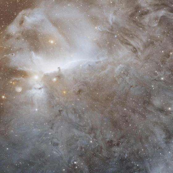 Image of space with cloud and nebula-like formations and luminous dots.