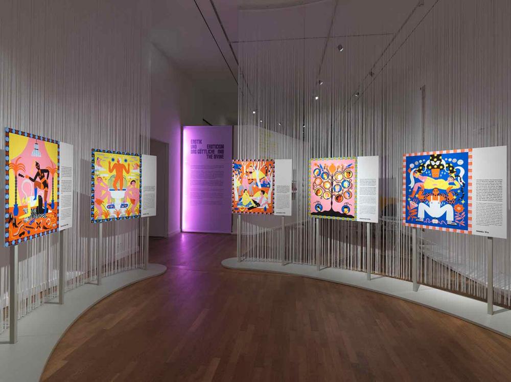 Exhibition view, shows displays with colorful illustrations and wall texts.