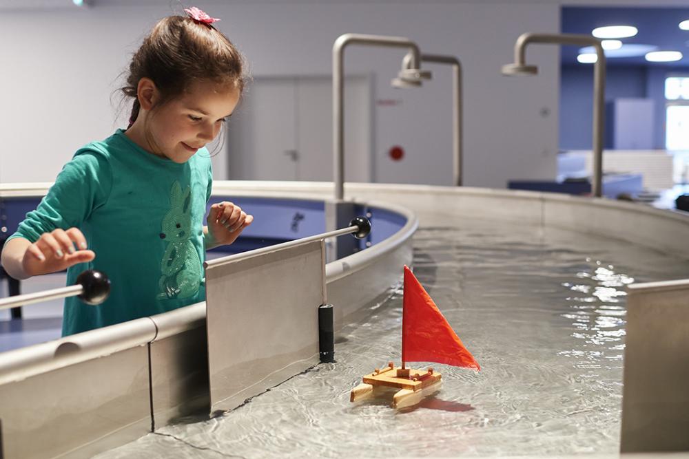 Girl at water station in the children's world Anoha.