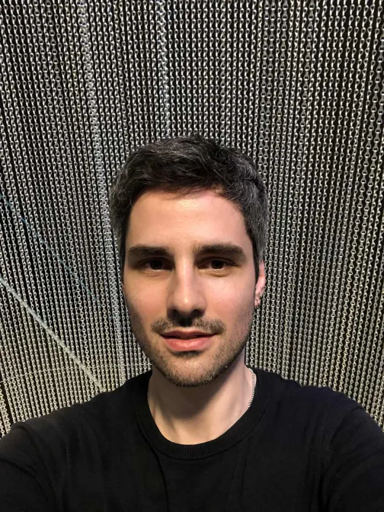 Selfie by Immanuel Ayx with chain curtain as background.