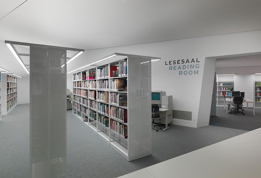 View of white bookshelves with colorful books