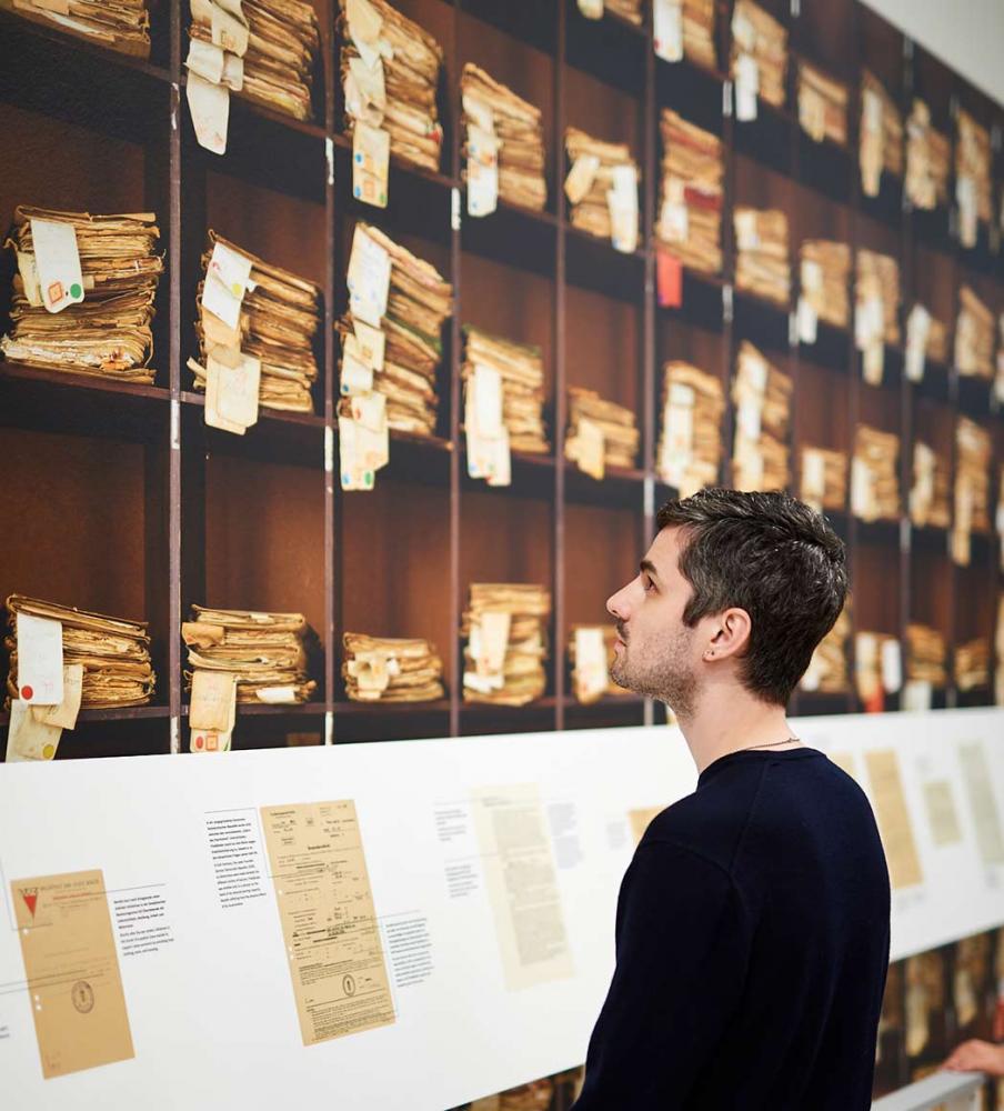 People in front of a space-consuming file shelf