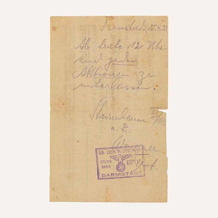 Handwritten note, stamped and signed by SA Troop Leader Wagner. The text reads “Darmstadt, 25 April 1933. From noon today, all actions are to stop.”