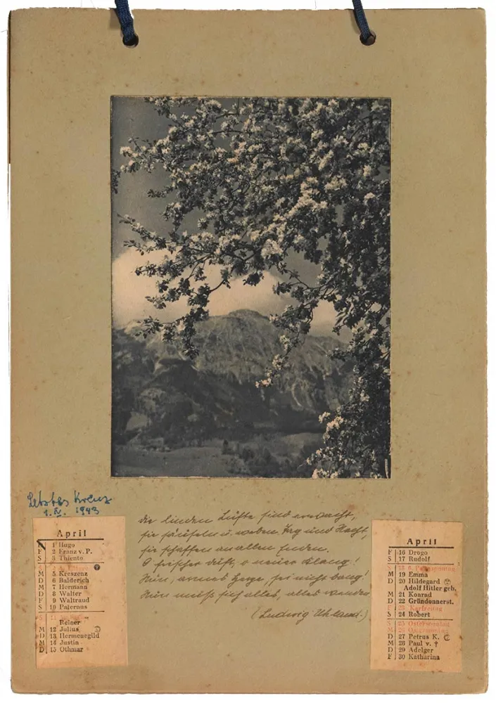 Photography: View of a calendar page with a glued-on county picture and handwritten text.