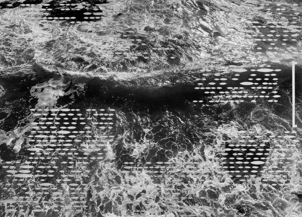 Black and white image of waves in the sea, overlaid with white dots.