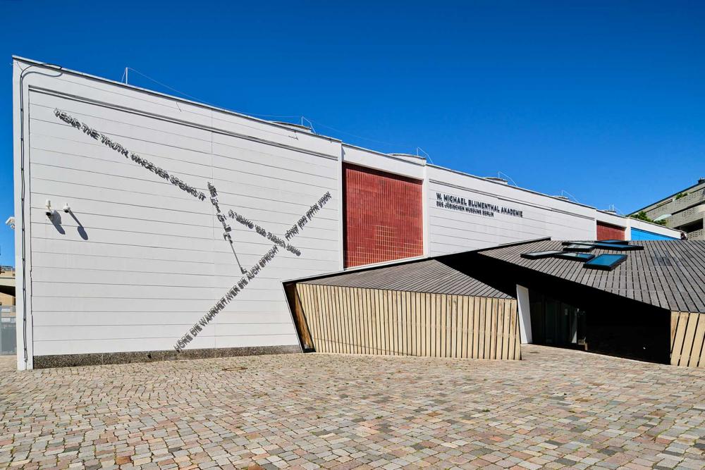 View from the side of the wooden main entrance to the academy building.