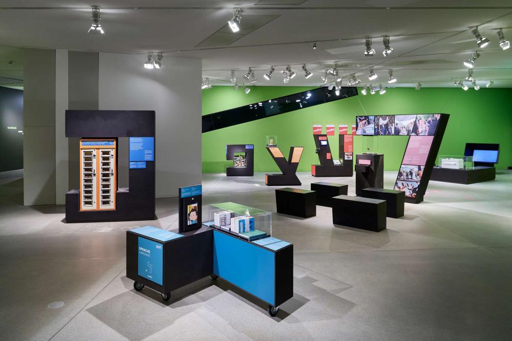 View of an exhibition hall with vitrines in form of huge Hebrew letters