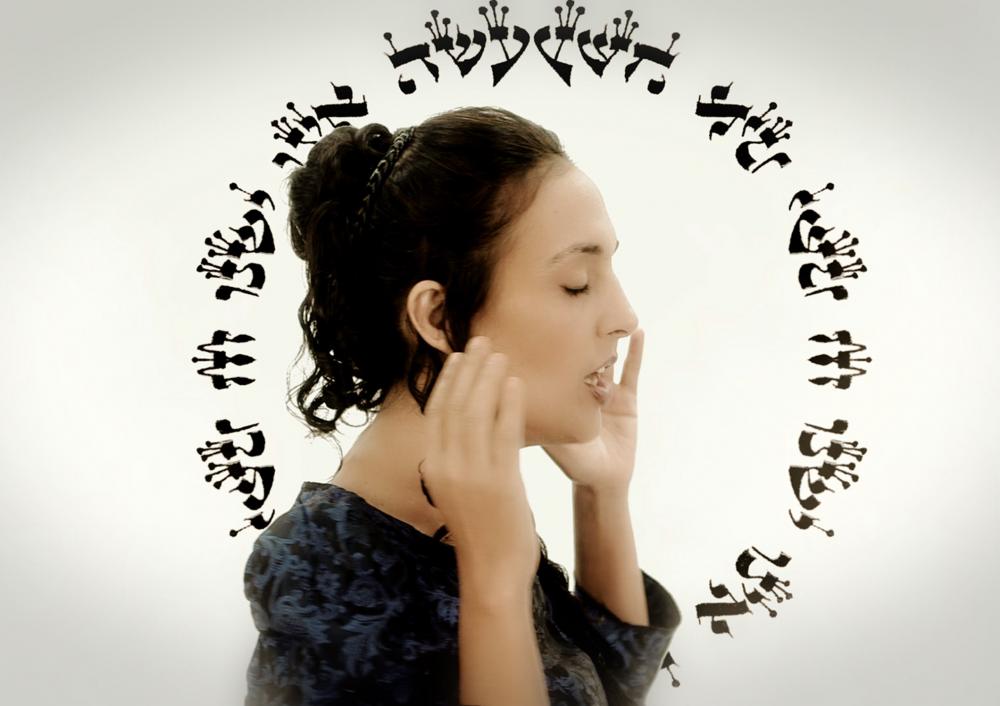 A woman in front of a circle made of letters