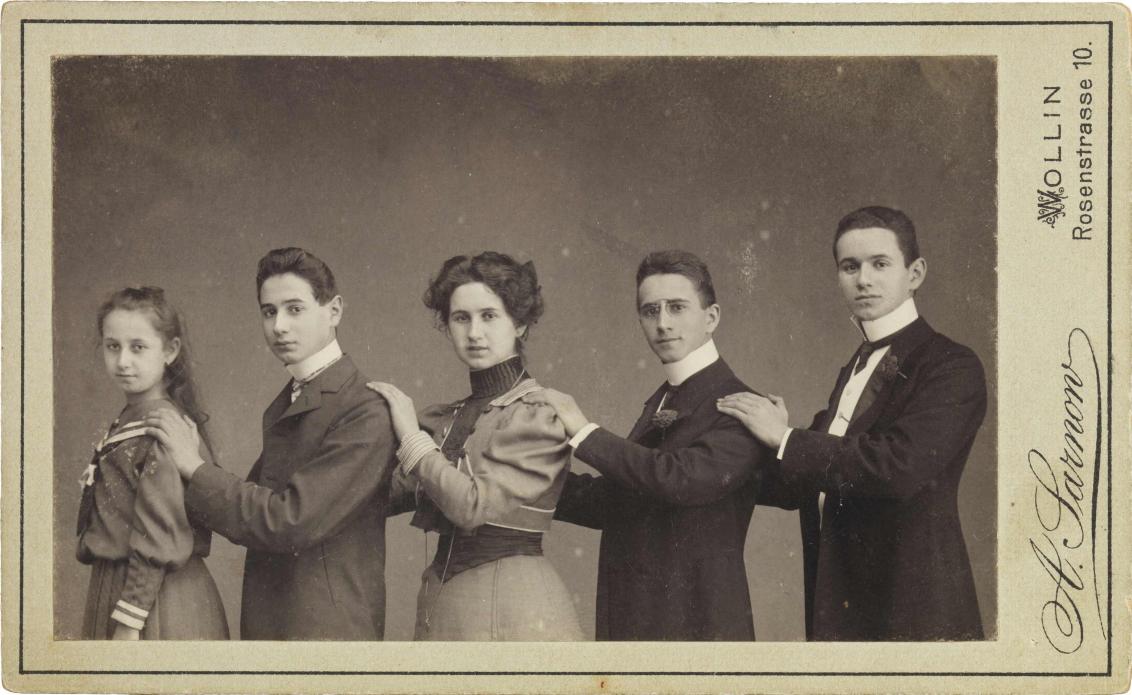 Black-and-white photograph: Five children standing according to size from left to right, studio photograph