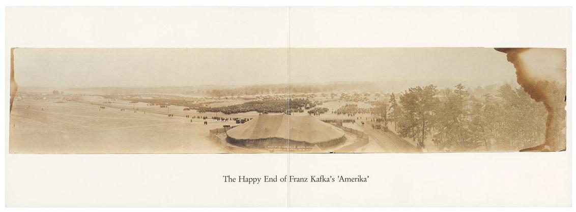 Fold-out card with a very horizontal sepia photograph of a circus tent in a landscape of fields and trees, with the text below: The Happy End of Franz Kafka’s ‘Amerika.’ 