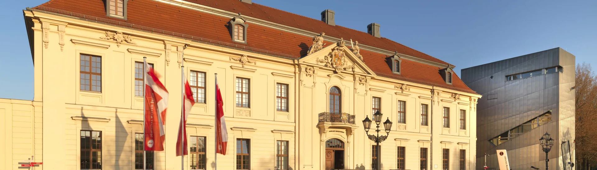 The Jewish Museum's Old Building in the evening sun, with three flags