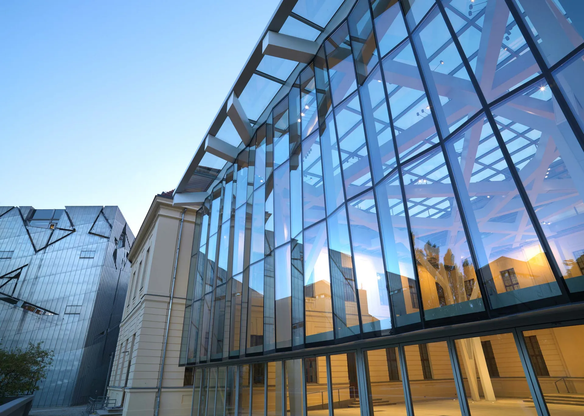 The outside of the Glass Courtyard; the glass reflects the evening sky