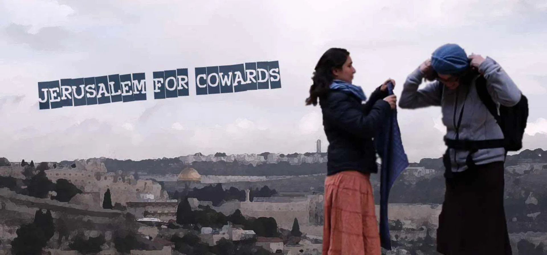 Two women about to cover their hair with a headscarf. In the background you can see Jerusalem and the writing “Jerusalem for corwards”.