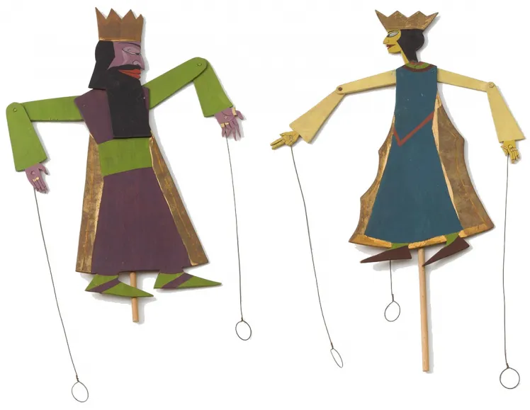 Two puppets with crowns and moving parts, which are connected with rivets