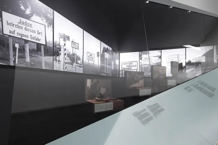 Photography: View into a showcase with photographies of anti-Semitic signs