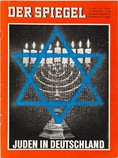 Cover of the news magazine “DER SPIEGEL”. It features a Hanukkah candlestick with lit candles and a blue Star of David, with the words “Jews in Germany” at the bottom of the cover.