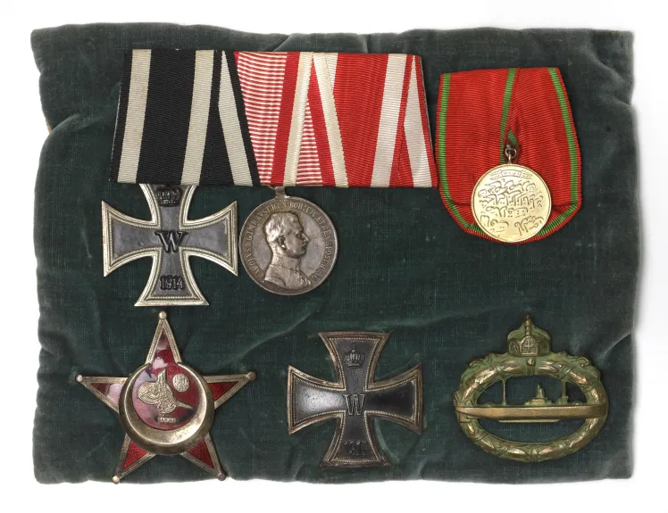 Six military medals on a velvet cushion